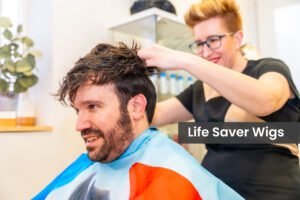 Close-up of friendly and cool hairdresser attaching a clean capillary prosthesis to a man